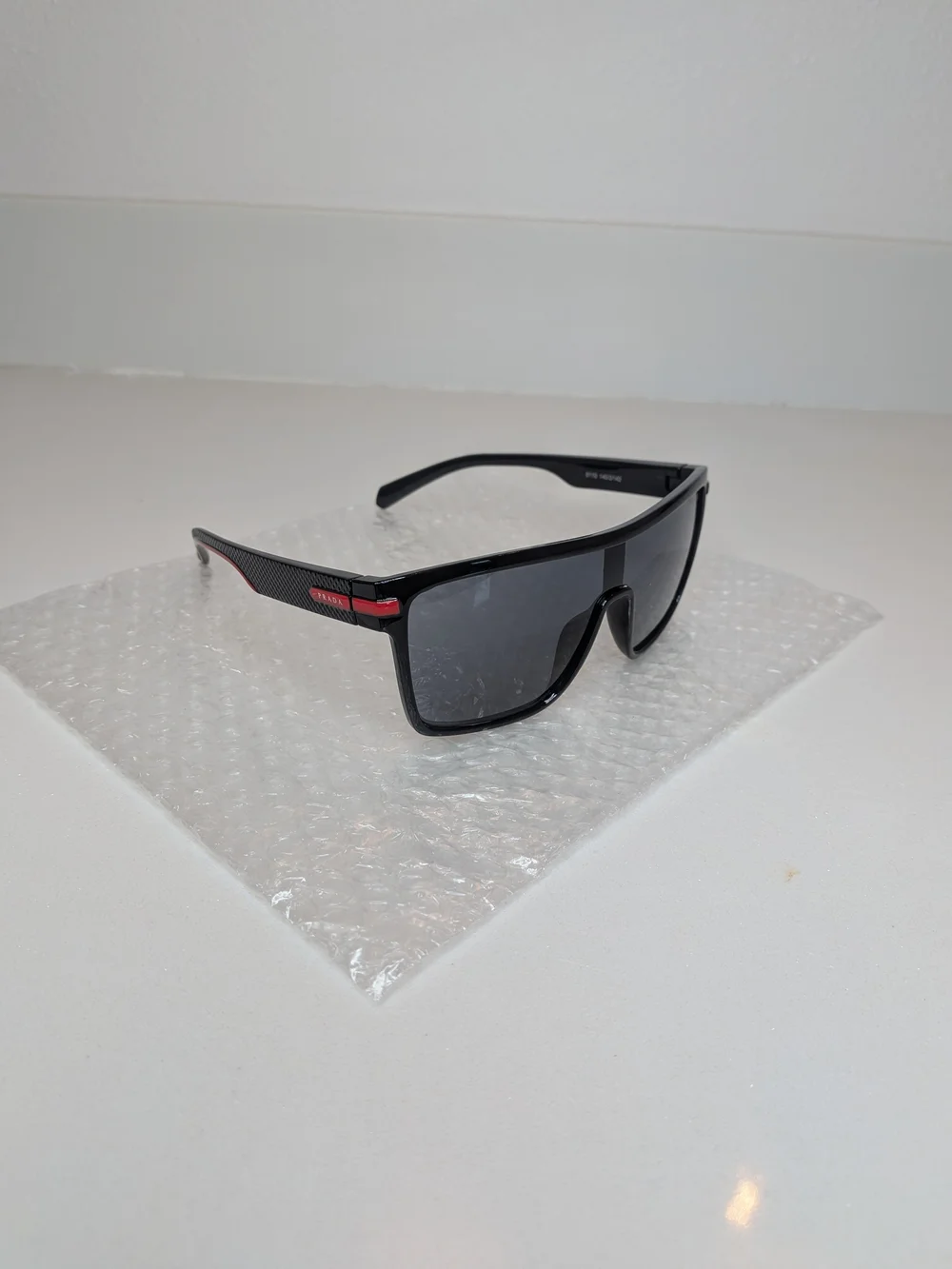 Prada Men’s Black Shield Sunglasses Red Logo Sport